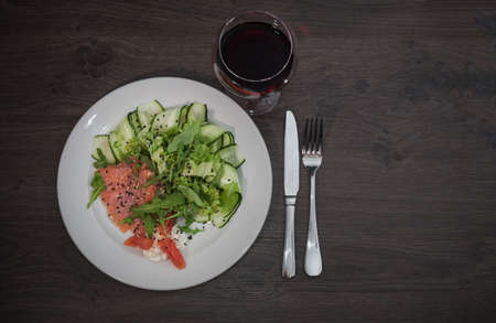 Meat of trout on a plate with vegetables and grapefruit.の写真素材