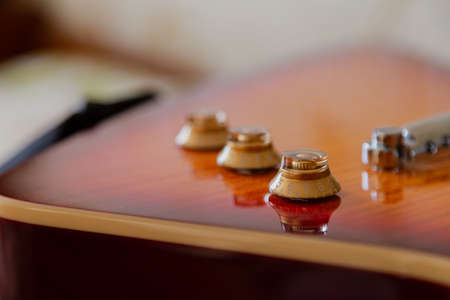 Electric guitar body and neck detail on wooden background vintage look