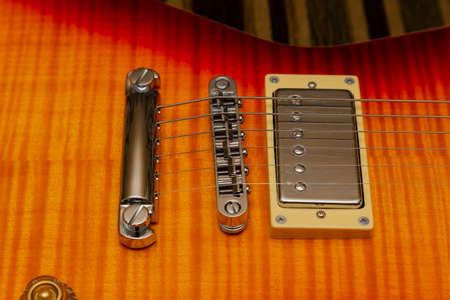 Electric guitar body and neck detail on wooden background vintage lookの写真素材