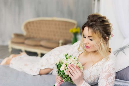 Beautiful woman in wedding dress in photo studio.