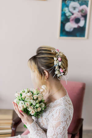 Beautiful woman in wedding dress in photo studio.