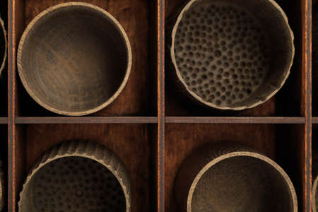 Wooden cups in a box for storing dishesの写真素材
