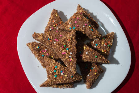 Cakes with a colorful sprinkling of stars on a white plateの写真素材