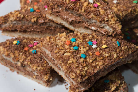 Cakes with a colorful sprinkling of stars on a white plateの写真素材