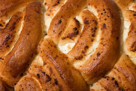 Fresh ruddy freshly cooked pie lies on the towelの写真素材