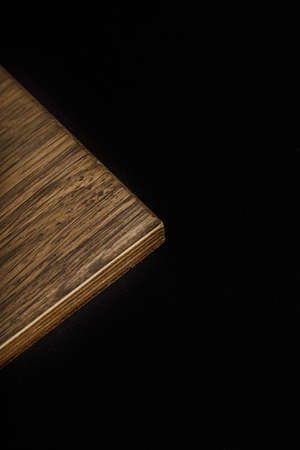 Wooden product made of wood on a black backgroundの写真素材