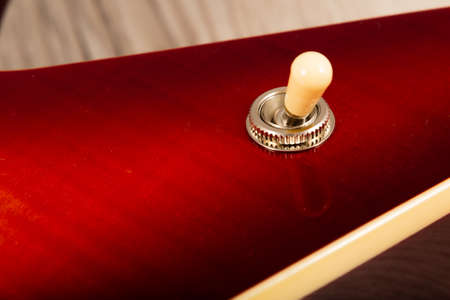 Old beautiful electric guitar on a background of wood