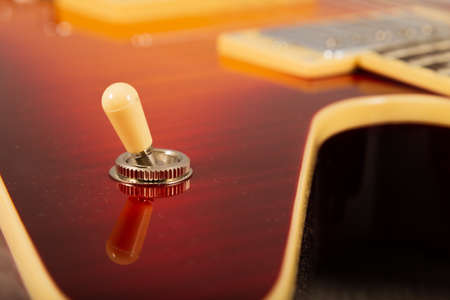Old beautiful electric guitar on a background of wood