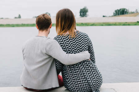Two lovers walk around the park, kiss and hug, a love story.