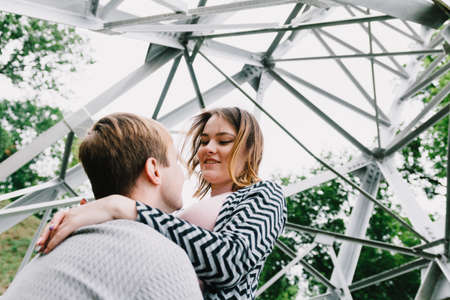 Two lovers walk around the park, kiss and hug, a love story.の写真素材