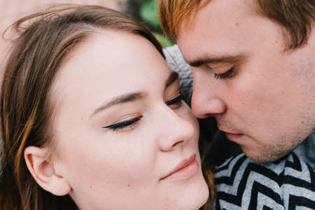 Two lovers walk around the park, kiss and hug, a love story.の写真素材