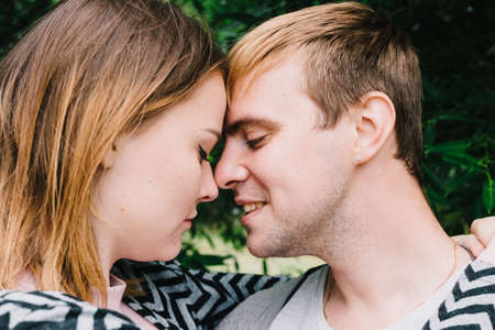 Two lovers walk around the park, kiss and hug, a love story.の写真素材