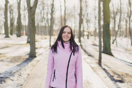 A woman is walking in the park