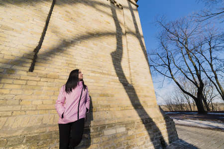 A woman is walking in the park