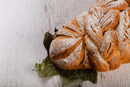 Freshly baked bread on a wooden background.