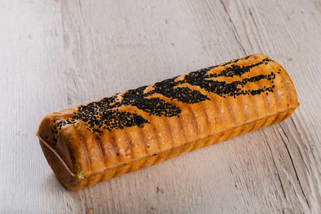 Freshly baked bread on a wooden background.