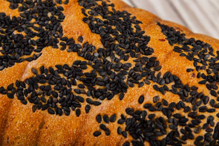 Freshly baked bread on a wooden background.