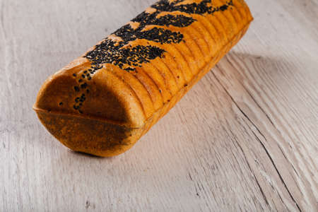 Freshly baked bread on a wooden background.の写真素材