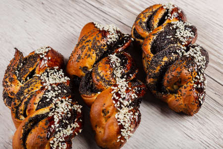 Ruddy fresh beautiful buns on a wooden background.の写真素材
