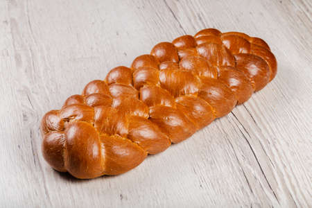 Freshly baked bread on a wooden background.