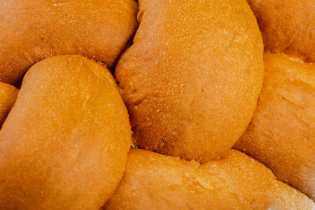 Freshly baked bread on a wooden background.