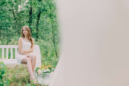 Very beautiful woman in nature surrounded by real flowers.の写真素材