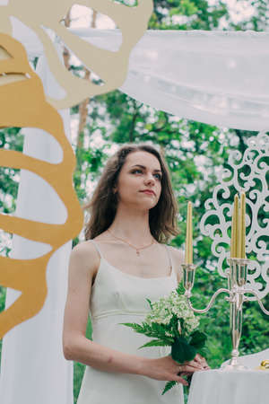 Very beautiful girl photographed in nature with fresh flowers.の写真素材