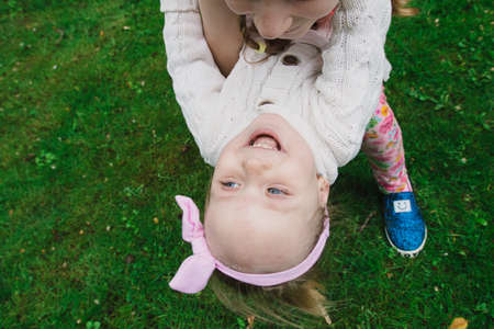 Children walk in the park on a day off. The sun is shining