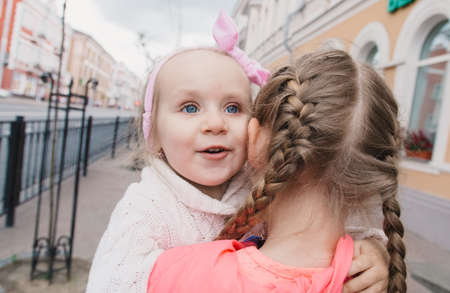 Children walk down the street and smileの写真素材