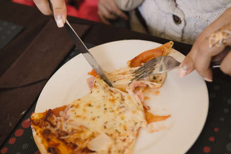 Mom and children eating pizza at a cafe