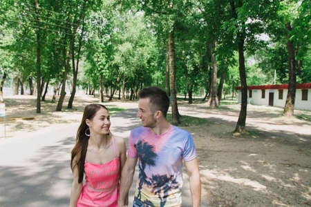 Young couple hugging and smiling each other walking on a bridge