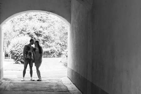 Young couple hugging and smiling at each other in the parkの写真素材