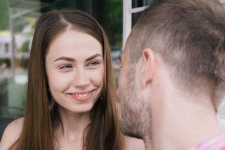 Young couple hugging and smiling at each other in the park