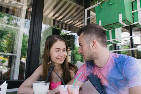 Young couple hugging and smiling at each other in the park