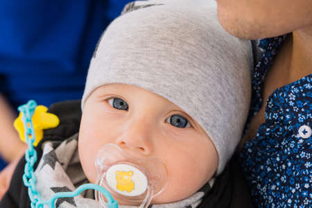 A happy married couple is sitting in a cafe and enjoying this time. They play with their child, he...