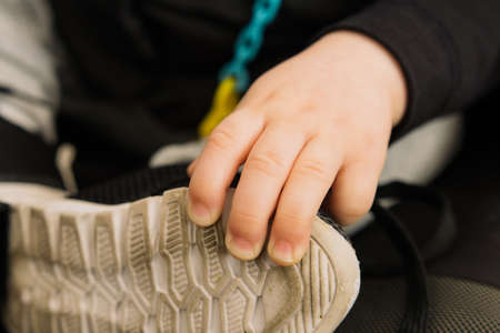 A baby in a wheelchair and smilingの写真素材