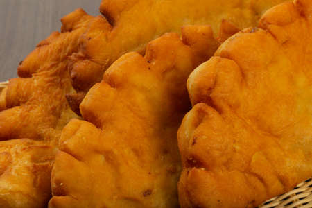 Chebureks made at home, crispy crust, wood background.