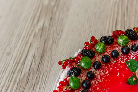 Delicious healthy vegetarian food, do not bake a strawberry cheesecake, decorated with fresh red berries and green mint leaves. Copy space.の写真素材