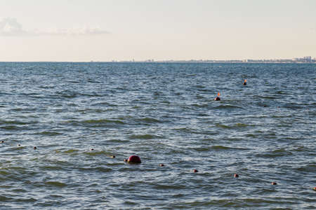 Red buoys in the open sea on a sunny day.