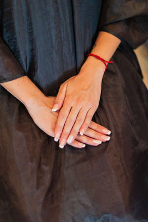 the girl is holding her hands on her kneesの写真素材