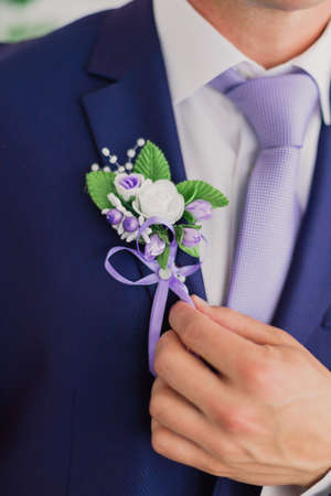 Morning groom, Groom in a jacket, The groom straightens the buttonhole, wedding day