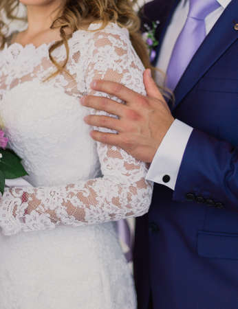 Newlyweds embracing at the door of the hotel. Gentle embrace of the newlyweds.の写真素材