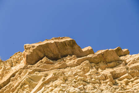 Rock naked breed on a cliff, rocks near the sea.