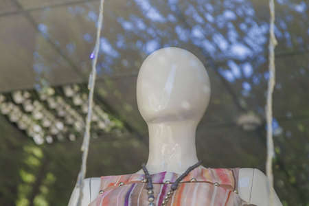 Two glamour blonde mannequins in a shopping mall. Cruel bitchy woman hatching up revenge behind friend's backの写真素材