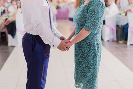 A man hands holding the hand of old woman.の写真素材