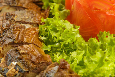 Sliced herring on a plate with herbsの写真素材