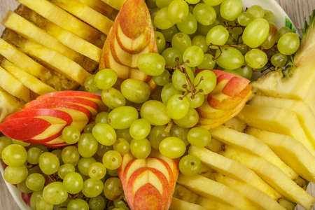 Very nice and artistically sliced fruits on a platter.の写真素材