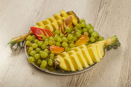 Very nice and artistically sliced fruits on a platter.の写真素材