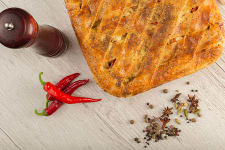 Meat pie on a wooden background with ingredients.の写真素材