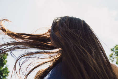 A very beautiful girl with black glasses waving her hairの写真素材